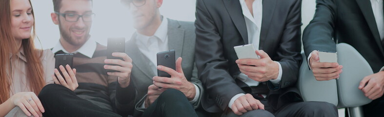 Group of young people use their phones