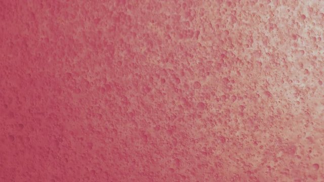 Analog Pink Micro Bubbles Falling Downwards Through Oily Fluid.