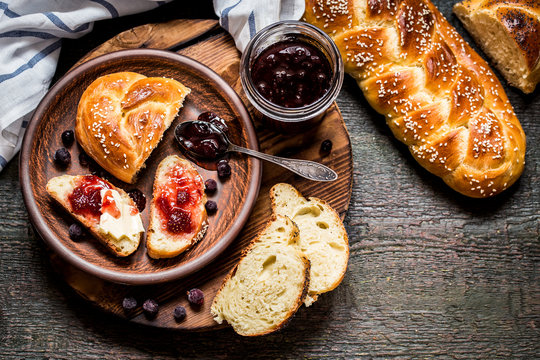 Challah is a Jewish bread to the feast on the dark wooden boards.