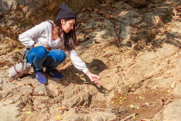 Woman hiking around mountains near the river at spring time.
