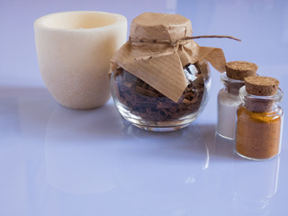 set ingredients and spice for aromatherapy and body care on a white surface with reflection. SPA still life