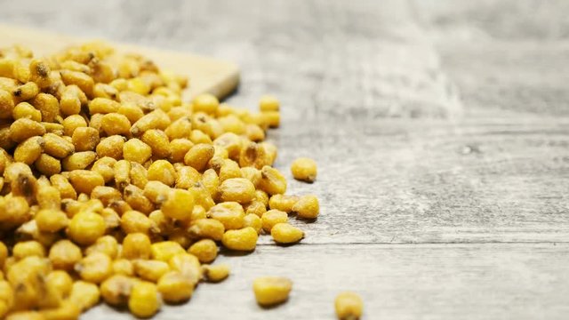 Roasted corn on wooden background in studio. Delicious salty roasted corn