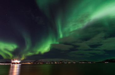 Naklejka na ściany i meble Amazing Aurora Borealis in North Norway above the sea, Tromso City