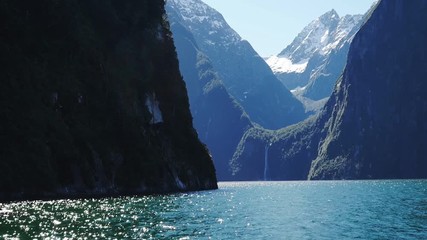 the view of sterling falls in milford sound from a cruise boat