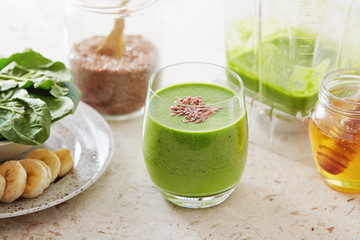 Healthy green smoothie made with spinach, banana and flax seed. 