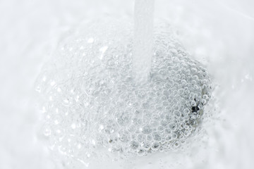 Water Running Down and Forming Bubbles on Sink Drain Hole