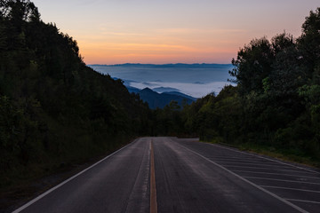 Empty road highway to next mountain during cold autumn in morning day before sunrise