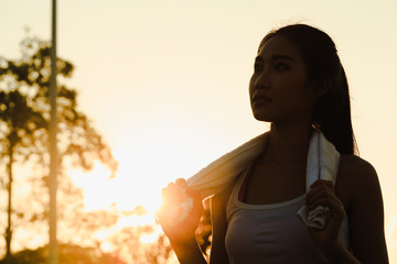 A women is  exercising and relaxing at the park.