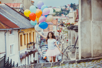Fototapeta premium Girl with colorful latex balloons