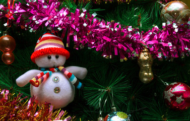Artificial Christmas tree with toys and a snowman