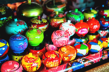 Fototapeta na wymiar Coconut shell bowls on the wooden shelf. Souvenir coconut bowls selling on the market