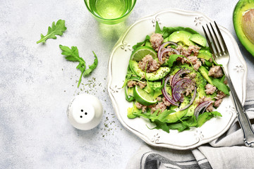 Tuna salad with avocado and arugula.Top view with copy space.