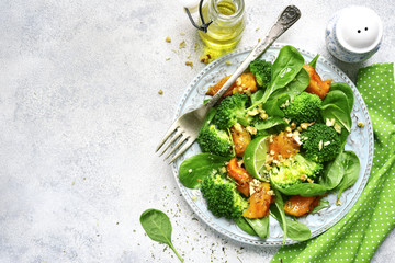 Pumpkin salad with spinach and broccoli.Top view with copy space.