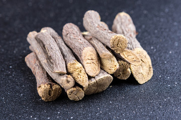 Pile of licorice roots isolated on a black background