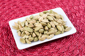 Pile of cardamom on a cloth background
