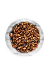 Pile of dried pomegranate seeds isolated on a white background