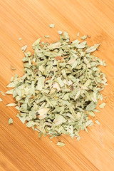 Pile of senna leaves isolated on a wood background