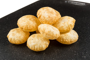 Puffed fried puri isolated on a black background