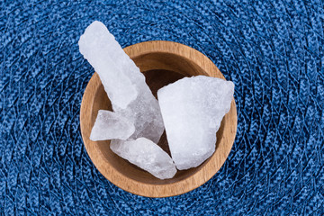 Crystallized alum chunks on a cloth background