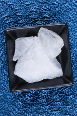 Crystallized alum chunks on a cloth background