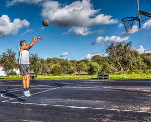 Side view of a lefty basketball player jump shot