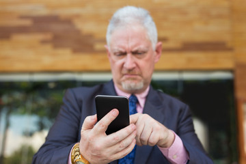 Tensed Business Leader Using Smartphone