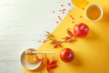 Composition with honey, apple and pomegranate for Rosh Hashanah holiday on white wooden background, top view © Africa Studio
