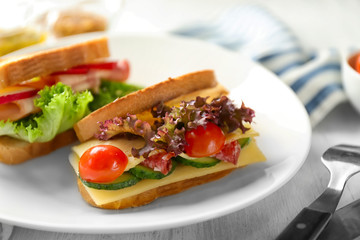 Plate with delicious sandwich on table, closeup