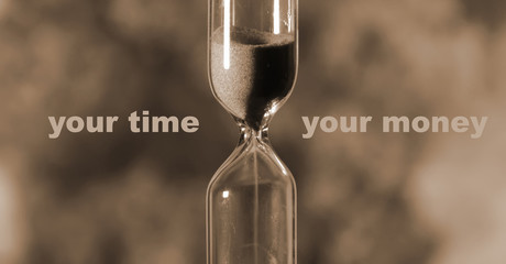 glass hourglass is pouring out the sand expires time. Your time your money