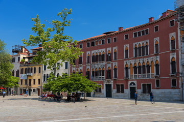 Fototapeta na wymiar Beautiful venetian street with old houses in a sunny summer day.