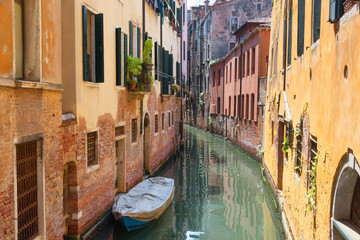 Naklejka na ściany i meble Traditional narrow canal street with gondolas and old houses in Venice, Italy. Architecture and landmarks of Venice. Beautiful Venice postcard.