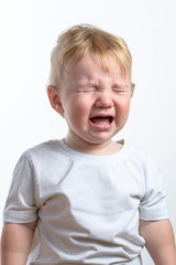 Little child cry. White background. Closeup.