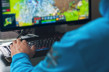 Man plays PC game at home