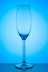 Closeup view of champagne glass on a blue gradient background