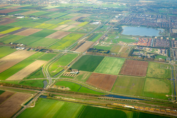 Aeral view on agricultural fields and railway with train