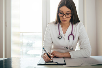 Female doctor at office desk