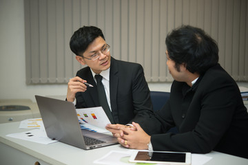 Fototapeta na wymiar Two asian businessmen discuss about business of company,Two people are talking about work stress and more serious.