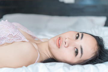 Portrait Asian sexy woman in the bed,Perfect portrait Thailand lady indoors,make sexy eyes