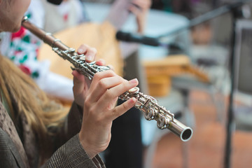 Fototapeta premium A girl plays a flute