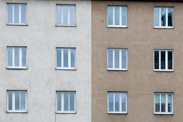 The facade of the building with windows symmetrically divided by color