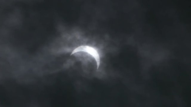 Partial solar eclipse filmed in daytime, with moon partially covering the sun. ProRes file, shot in 4K UHD.