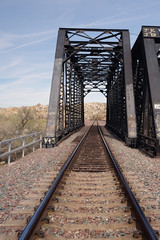 A steel truss bridge and train tracks in Victorville, California, USA.