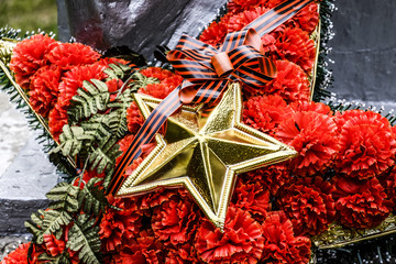 Wreath with a star on the monument. Victory Day. Symbols of the day of victory over fascist Germany.