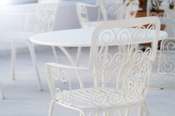 Openwork white . metal chair in the cafe