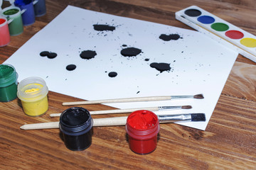 gouache, tassels, watercolor paint, white sheet of paper.