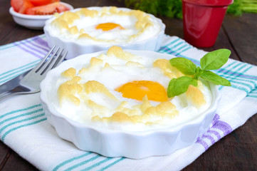 Delicate baked egg Orsini (eggs in the cloud). French breakfast.