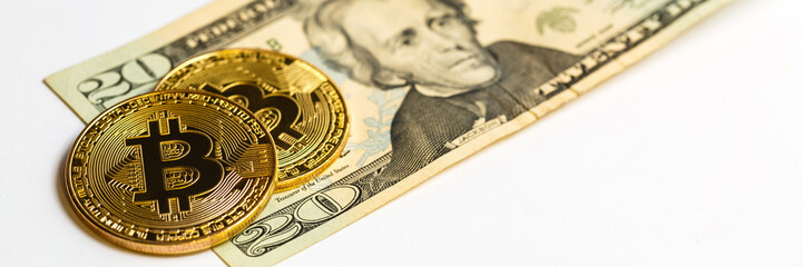 Fototapeta na wymiar Gold bitcoin on a white background next to us paper money with a face value of dollars