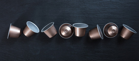 Espresso coffee pods isolated on black background, Top view, banner