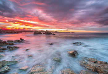 spectacular and colorful sunset on the beach of Arnao