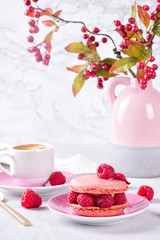 Romantic breakfast with coffee and pink raspberry macaron